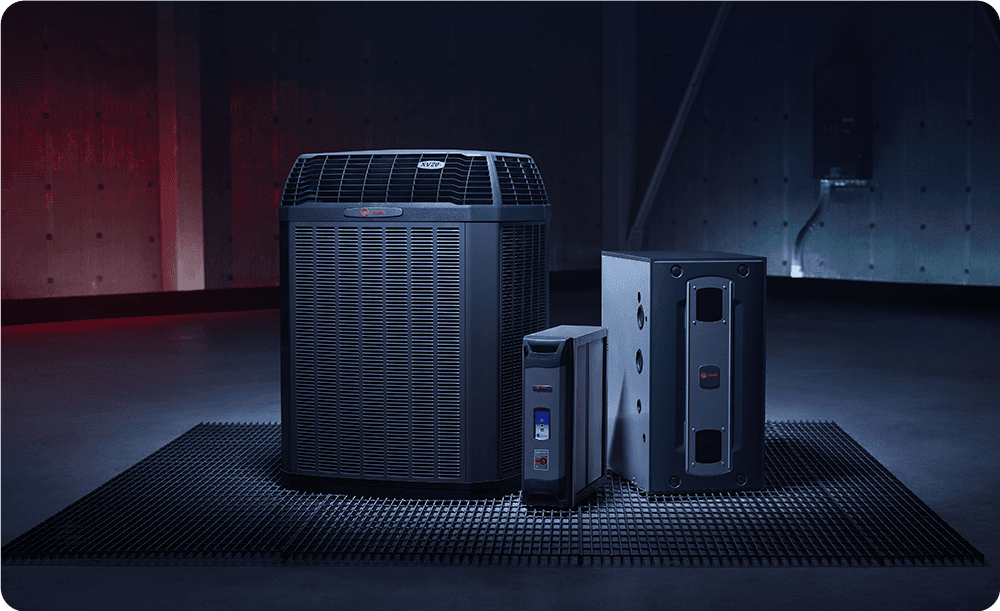 A heat pump, thermostat, and a furnace are on display.