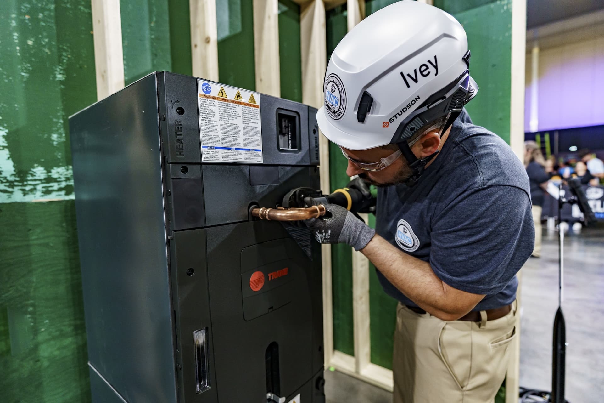 An HVAC technician is working on a Trane air handler.