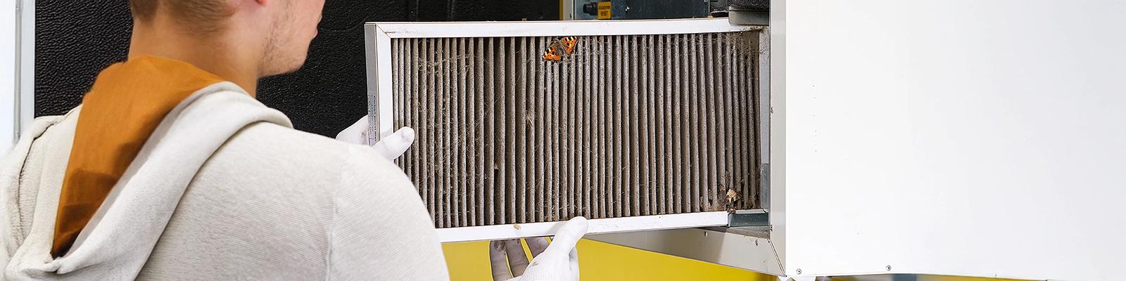 HVAC Technician Changing a Furnace Filter